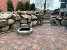 boulder retaining wall and firepit patio