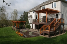 Brown second story deck with stained wood pergola and railing